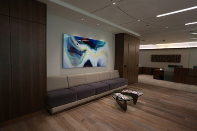 Home studio - huge contemporary freestanding desk light wood floor home studio idea in Los Angeles with beige walls