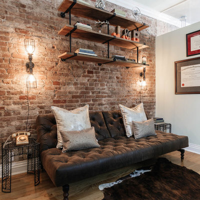 Small urban freestanding desk medium tone wood floor and brown floor study room photo in New York with beige walls and no fireplace