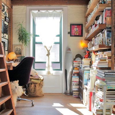 Home office - rustic built-in desk light wood floor home office idea in New York with white walls and no fireplace