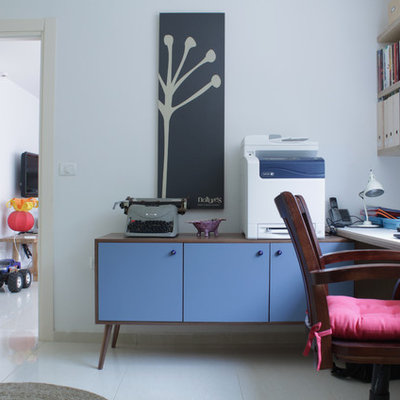 Inspiration for an eclectic freestanding desk white floor home office remodel in Tel Aviv with white walls