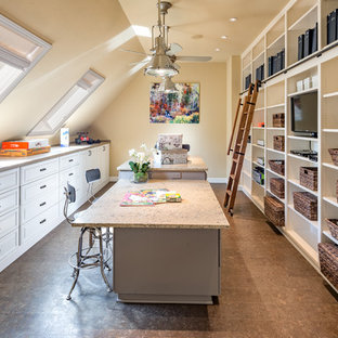 Craft room - traditional built-in desk brown floor craft room idea in San Francisco with beige walls