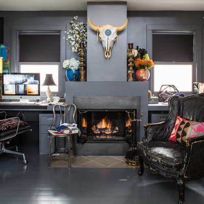 Example of a mid-sized eclectic built-in desk painted wood floor study room design in Los Angeles with gray walls, a standard fireplace and a plaster fireplace