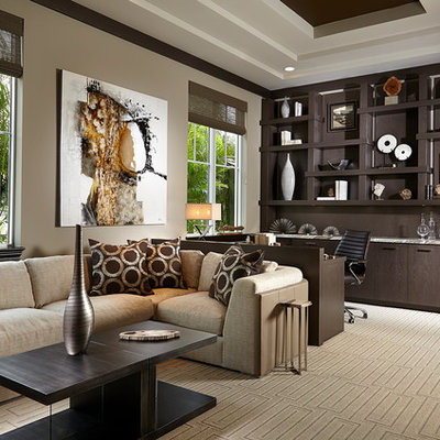 Example of a large transitional built-in desk carpeted and beige floor study room design in Miami with beige walls