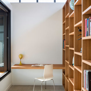Mid-sized contemporary home office in Sydney with white walls, concrete floors, grey floor, no fireplace and a built-in desk.