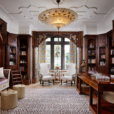 Large elegant freestanding desk light wood floor study room photo in Miami