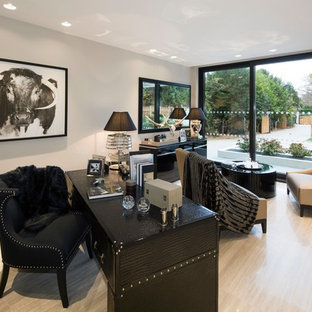 Design ideas for a medium sized contemporary study in London with grey walls, light hardwood flooring, a freestanding desk and beige floors.