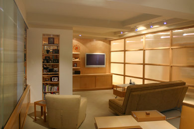 Example of a trendy carpeted home office design in New York with beige walls