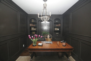 Example of a mid-sized classic freestanding desk dark wood floor study room design in Toronto with black walls and no fireplace
