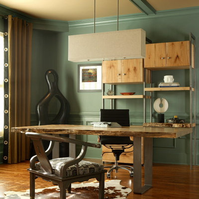 Inspiration for a mid-sized eclectic freestanding desk medium tone wood floor and brown floor study room remodel in Atlanta with green walls and no fireplace