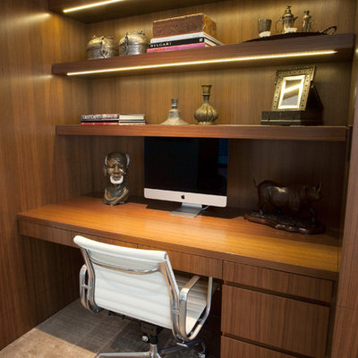 Example of a small trendy built-in desk carpeted study room design in Vancouver with brown walls and no fireplace