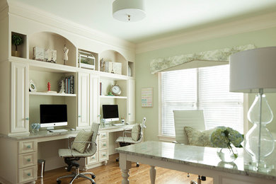 Inspiration for a medium sized traditional home office in Atlanta with green walls, medium hardwood flooring and a built-in desk.