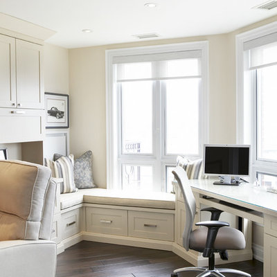 Inspiration for a timeless built-in desk dark wood floor home office remodel in Toronto with beige walls