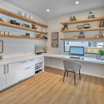 Example of a trendy built-in desk light wood floor study room design in Edmonton with white walls and no fireplace
