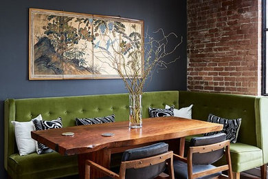 Urban medium tone wood floor and brown floor dining room photo in San Francisco with black walls