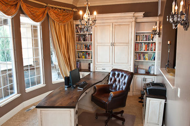 Medium sized classic study in Boise with brown walls, carpet and a built-in desk.