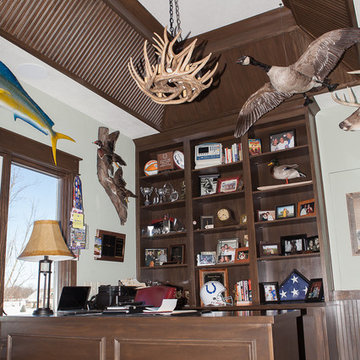 Office with wood-trimmed ceiling and built-ins