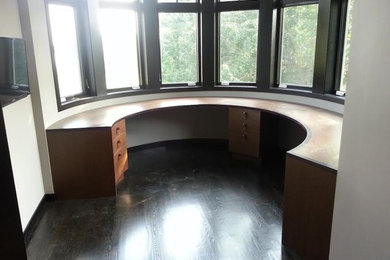 Mid-sized elegant medium tone wood floor home office photo in New York