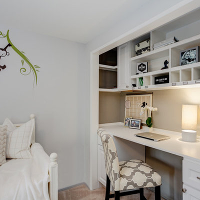Example of a small classic built-in desk carpeted study room design in Los Angeles with gray walls