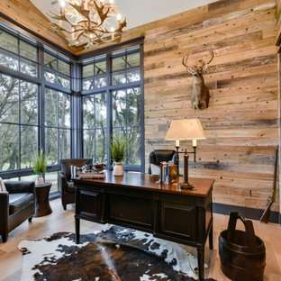 Uriges Arbeitszimmer ohne Kamin mit hellem Holzboden, freistehendem Schreibtisch, gewölbter Decke und Holzwänden in Austin