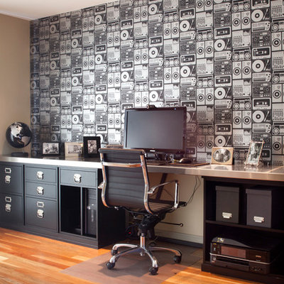Example of a trendy built-in desk medium tone wood floor study room design in San Francisco with multicolored walls