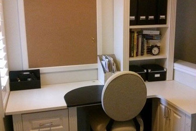 Mid-sized transitional built-in desk medium tone wood floor and brown floor study room photo in Toronto with beige walls