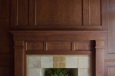 Example of a mid-sized classic dark wood floor study room design in Detroit with brown walls, a standard fireplace and a tile fireplace