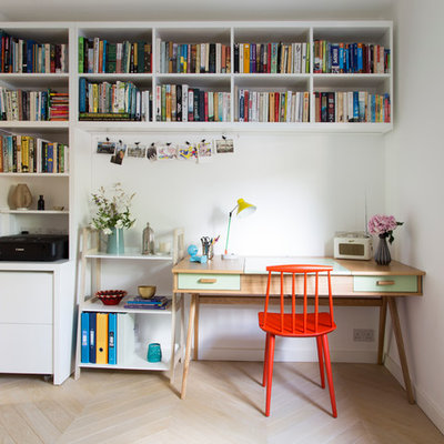 Study room - small contemporary freestanding desk light wood floor study room idea in London with white walls