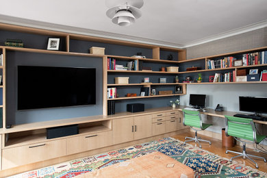 Inspiration for a mid-sized contemporary built-in desk medium tone wood floor and brown floor study room remodel in New York with gray walls