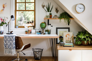 Trendy freestanding desk study room photo in Denver with white walls