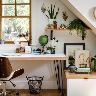 Trendy freestanding desk study room photo in Denver with white walls