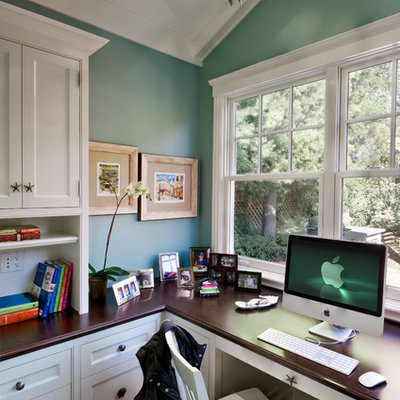 Example of a classic built-in desk dark wood floor home office design in San Francisco with blue walls