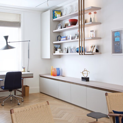 Inspiration for a mid-sized contemporary freestanding desk beige floor study room remodel in London with white walls
