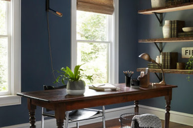 Inspiration for a transitional freestanding desk medium tone wood floor and brown floor home office remodel in Nashville with blue walls
