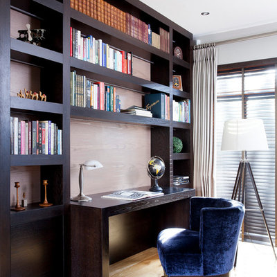 Example of a transitional built-in desk light wood floor study room design in Other with gray walls