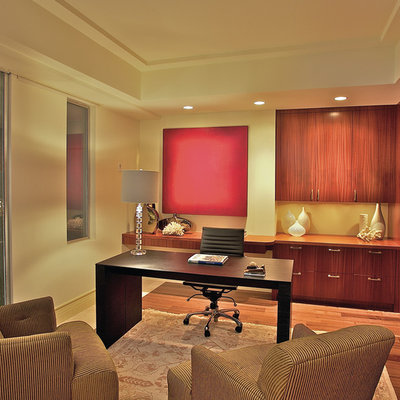 Home office - contemporary freestanding desk medium tone wood floor home office idea in San Francisco with beige walls