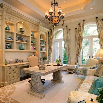 Inspiration for a mid-sized mediterranean freestanding desk dark wood floor and beige floor study room remodel in Miami with white walls and no fireplace