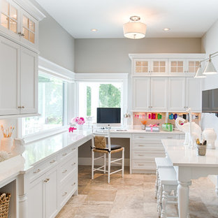 Inspiration for a timeless built-in desk craft room remodel in New York with gray walls