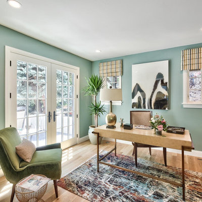 Study room - transitional freestanding desk light wood floor study room idea in Denver with green walls and no fireplace