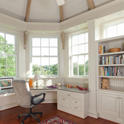 Example of a mid-sized classic built-in desk medium tone wood floor and brown floor study room design in San Francisco with white walls and no fireplace