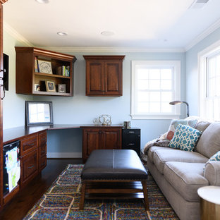 Inspiration for a mid-sized transitional built-in desk dark wood floor and brown floor home office remodel in Other with blue walls and no fireplace