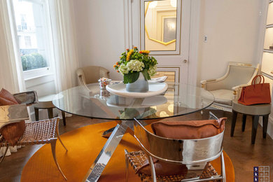 Medium sized bohemian dining room in London with beige walls and medium hardwood flooring.