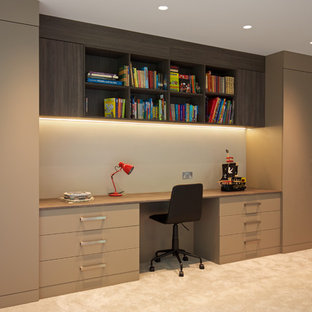 Inspiration for a large contemporary study in Hertfordshire with white walls, carpet, a built-in desk and beige floors.