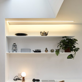 Scandi study in London with white walls and a built-in desk.