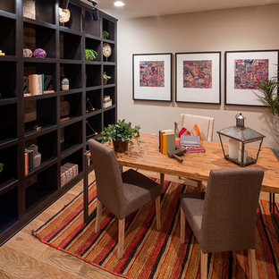 Study room - contemporary freestanding desk light wood floor study room idea in Los Angeles with gray walls