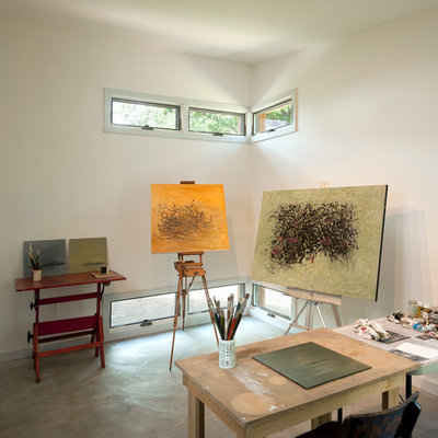 Example of a small trendy freestanding desk concrete floor and gray floor home studio design in DC Metro with white walls and no fireplace