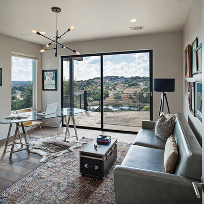 Inspiration for a mid-sized transitional freestanding desk dark wood floor and brown floor study room remodel in Austin with beige walls and no fireplace