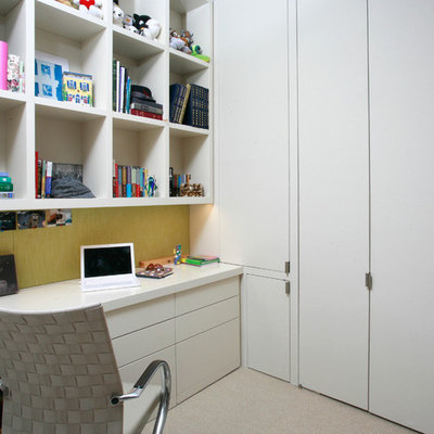 Example of a trendy built-in desk carpeted home office design in New York