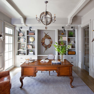 Example of a classic freestanding desk medium tone wood floor study room design in Atlanta with gray walls