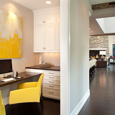 Transitional built-in desk dark wood floor study room photo in Minneapolis with beige walls and no fireplace