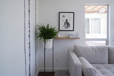 This is an example of a medium sized contemporary study in San Francisco with white walls, dark hardwood flooring, no fireplace, a freestanding desk and brown floors.